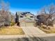 Two-story home featuring a two-car garage, solar panels and a well-maintained front lawn with mature landscaping at 474 Rose Finch Cir, Highlands Ranch, CO 80129