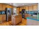 Spacious kitchen with stainless steel appliances, light wood cabinets, and an island with lots of space and storage at 474 Rose Finch Cir, Highlands Ranch, CO 80129