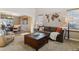 Cozy living room with comfortable seating, neutral tones, a unique wall decoration, and abundant natural light at 474 Rose Finch Cir, Highlands Ranch, CO 80129