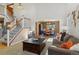 Bright living room with a staircase, a view into the dining area, and comfortable seating, creating a welcoming space at 474 Rose Finch Cir, Highlands Ranch, CO 80129
