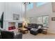 Open living room features soaring ceilings, a fireplace, large windows, and comfortable seating at 474 Rose Finch Cir, Highlands Ranch, CO 80129