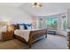 Main bedroom features a bay window with a bench, side tables, and a ceiling fan at 474 Rose Finch Cir, Highlands Ranch, CO 80129