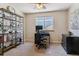 Bright office space with a modern desk, chair, shelving and natural light from a window at 474 Rose Finch Cir, Highlands Ranch, CO 80129