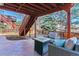 Cozy covered patio features stone pavers, comfortable seating and a fire table, perfect for outdoor relaxation at 474 Rose Finch Cir, Highlands Ranch, CO 80129