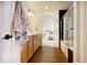 Hall bath featuring dual vanity, walk-in shower, and views to bedroom at 16357 E 111Th Pl, Commerce City, CO 80022