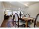 Modern dining room with a rustic wooden table, seating for six, and an open layout connecting to the cozy living area at 16357 E 111Th Pl, Commerce City, CO 80022