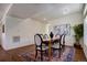 Inviting dining area featuring a wooden table with seating for six, complemented by a vibrant patterned rug and warm lighting at 16357 E 111Th Pl, Commerce City, CO 80022