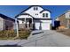 Charming two-story home boasting a modern design, stone accents, and a well-manicured front yard at 16357 E 111Th Pl, Commerce City, CO 80022