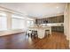 Open-concept kitchen with an island, barstool seating, and sleek cabinetry at 16357 E 111Th Pl, Commerce City, CO 80022