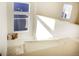 Sun-drenched landing with modern windows, a cozy window seat with pillows, and clean architectural lines at 16357 E 111Th Pl, Commerce City, CO 80022