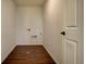 A utility room with wood-look flooring, white walls and hookups for laundry appliances at 16357 E 111Th Pl, Commerce City, CO 80022