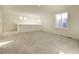 Spacious living room with carpeted floors and natural light at 16357 E 111Th Pl, Commerce City, CO 80022