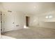 Large carpeted living room featuring natural light and access to rooms at 16357 E 111Th Pl, Commerce City, CO 80022