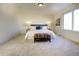 Spacious bedroom with a king bed, large window, and carpeted floor at 16357 E 111Th Pl, Commerce City, CO 80022