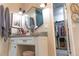 Bathroom with vanity, hexagonal mirror, and walk-in closet at 11100 Yarrow St, Broomfield, CO 80021