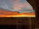 Stunning sunset view from a window overlooking open space at 11100 Yarrow St, Broomfield, CO 80021