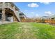 Spacious backyard with green lawn and privacy fence, perfect for outdoor activities at 141 Back Nine Dr, Castle Pines, CO 80108