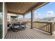 Backyard deck with an outdoor dining table and decorative overhead string lights at 141 Back Nine Dr, Castle Pines, CO 80108