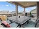 Outdoor backyard deck featuring a large dining table and decorative string lights at 141 Back Nine Dr, Castle Pines, CO 80108