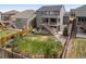 Aerial view of the home's spacious backyard, including a patio, shed, and fenced yard at 141 Back Nine Dr, Castle Pines, CO 80108