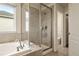 Bright bathroom featuring a soaking tub and a glass-enclosed shower offering a relaxing experience at 141 Back Nine Dr, Castle Pines, CO 80108