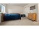 Comfortable bedroom featuring a wooden bed, storage dresser, and a beanbag seat at 141 Back Nine Dr, Castle Pines, CO 80108