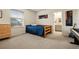 Cozy bedroom with a wood frame bed, carpet, and window providing natural light at 141 Back Nine Dr, Castle Pines, CO 80108