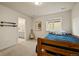 Comfortable bedroom with natural light, wooden bed frame, and easy access to bathroom at 141 Back Nine Dr, Castle Pines, CO 80108