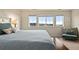 Bright bedroom with many windows, cozy chair, and decorative touches for a tranquil and inviting space at 141 Back Nine Dr, Castle Pines, CO 80108