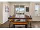Cozy dining area featuring large table, wood chairs, and access to a deck or patio at 141 Back Nine Dr, Castle Pines, CO 80108