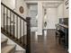 Bright foyer with hardwood floors, piano, and stairway at 141 Back Nine Dr, Castle Pines, CO 80108