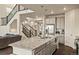 Bright kitchen features a large granite island, stainless steel appliances, and pendant lighting at 141 Back Nine Dr, Castle Pines, CO 80108