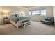 Spacious main bedroom featuring tray ceiling, ample natural light, and neutral decor at 141 Back Nine Dr, Castle Pines, CO 80108