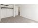 Bright bedroom featuring neutral carpeting, white walls, and a closet with shelving system at 14703 E Caspian Pl, Aurora, CO 80014