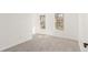 Sunny bedroom featuring neutral carpeting, white walls, and two bright windows at 14703 E Caspian Pl, Aurora, CO 80014