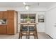 Eat-in kitchen featuring tile floors, white ceiling fan, table and 4 chairs and sliding glass door at 14703 E Caspian Pl, Aurora, CO 80014