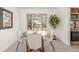 Bright dining room with a bay window and modern furniture at 14703 E Caspian Pl, Aurora, CO 80014