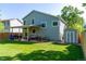 Expansive backyard with a lush lawn, patio, shed, and privacy fence at 11777 Elizabeth Cir, Thornton, CO 80233