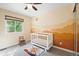 Adorable Bedroom featuring unique wall art and a bright window overlooking the outdoors at 11777 Elizabeth Cir, Thornton, CO 80233