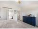 Bright bedroom featuring neutral walls, an open doorway to the en-suite bath and a view to a stairway at 11777 Elizabeth Cir, Thornton, CO 80233