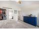 Bright bedroom featuring neutral walls, a well-stocked walk-in closet and a view to the en-suite bath and stairwell at 11777 Elizabeth Cir, Thornton, CO 80233