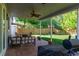 Covered patio with string lights, ceiling fan, and views of the green backyard at 11777 Elizabeth Cir, Thornton, CO 80233