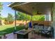 Inviting covered patio with outdoor seating and a green backyard at 11777 Elizabeth Cir, Thornton, CO 80233
