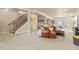 Spacious finished basement with carpet, stairs, and comfortable seating with a leather chair at 17956 Gypsum Canyon Ct, Monument, CO 80132