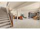 Open basement area with carpeted floors, stairs, and versatile living spaces at 17956 Gypsum Canyon Ct, Monument, CO 80132