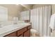 Well-lit bathroom features a vanity with a solid-surface countertop and a shower-tub combo at 17956 Gypsum Canyon Ct, Monument, CO 80132