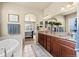 Elegant bathroom with double vanity, granite countertop, soaking tub, and access to main bedroom at 17956 Gypsum Canyon Ct, Monument, CO 80132