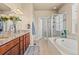 Luxurious bathroom featuring a soaking tub, glass-enclosed shower, and granite countertops at 17956 Gypsum Canyon Ct, Monument, CO 80132