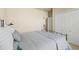 Comfortable bedroom with neutral tones, a gray patterned quilt, and a spacious closet at 17956 Gypsum Canyon Ct, Monument, CO 80132
