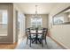 Cozy dining room with wood table, modern chandelier, and ample natural light at 17956 Gypsum Canyon Ct, Monument, CO 80132